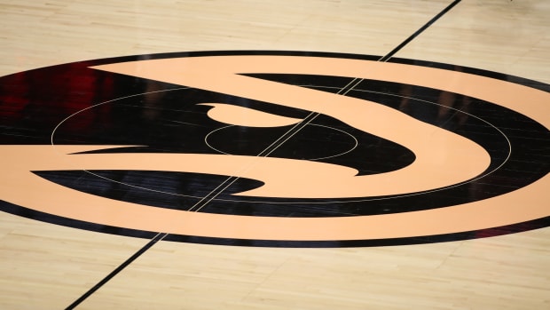 Black and peach Hawks logo at midcourt.